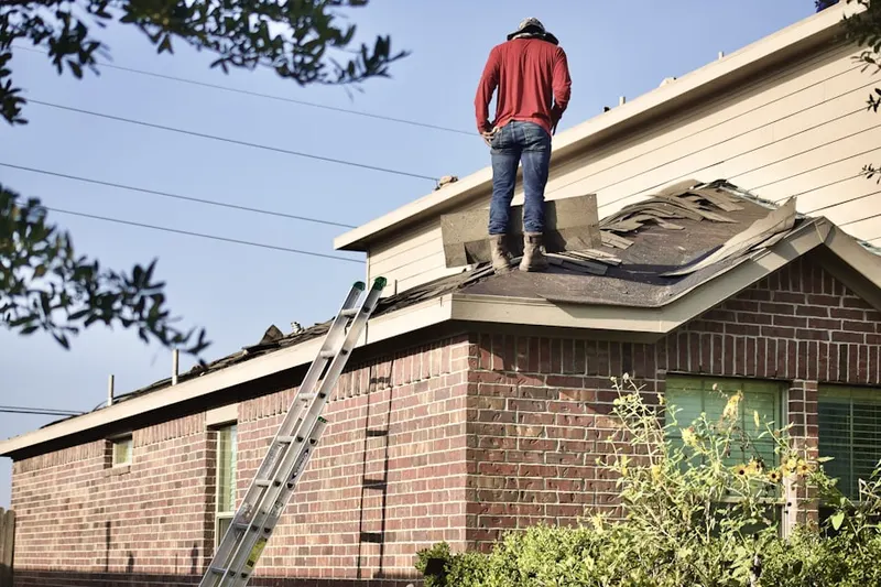 Professional roofer working on a residential roof in Steele Creek